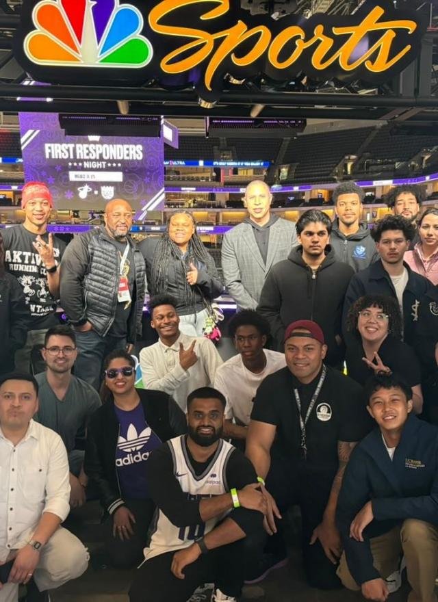 a group shot of mentees and MBA students at Golden 1 Center