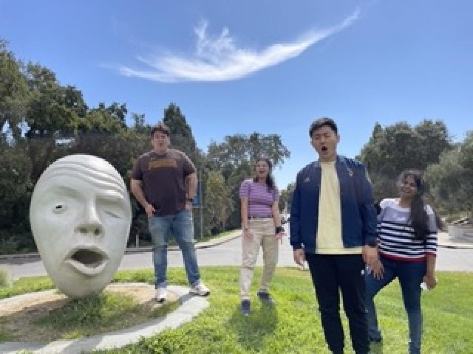 UC Davis students in front of Egghead sculpture