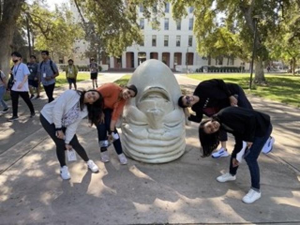 Students in from of UC Davis Egghead sculpture