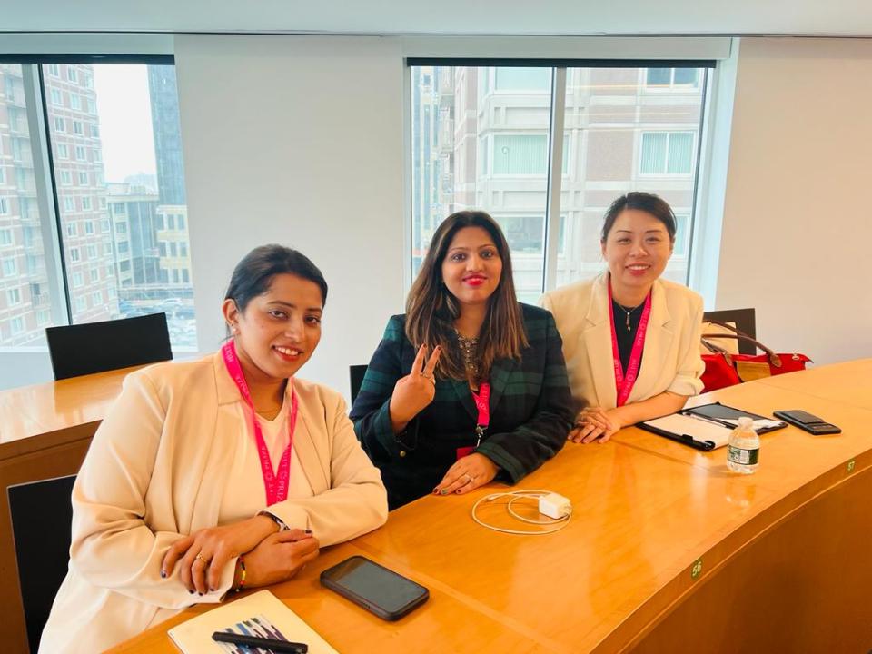 Faye Wu, Amita Nair and Kritika Singh sitting at a desk