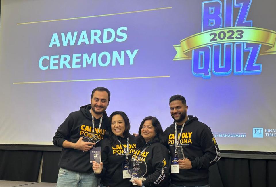 Four Cal Poly Pomona students holding up their award