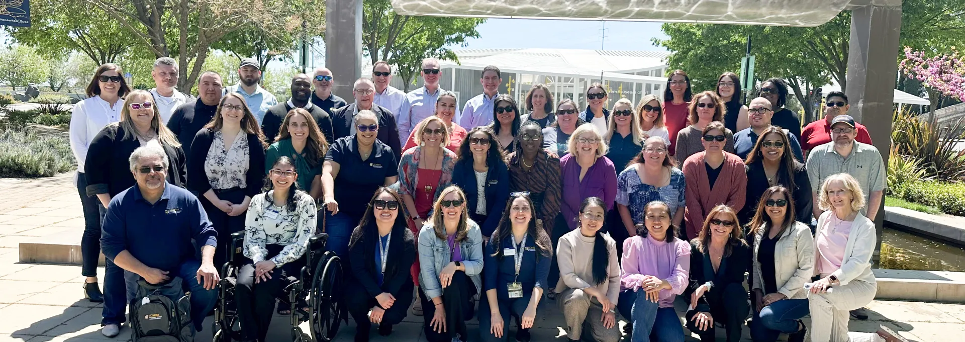 Group of GSM staff members in front of fountain