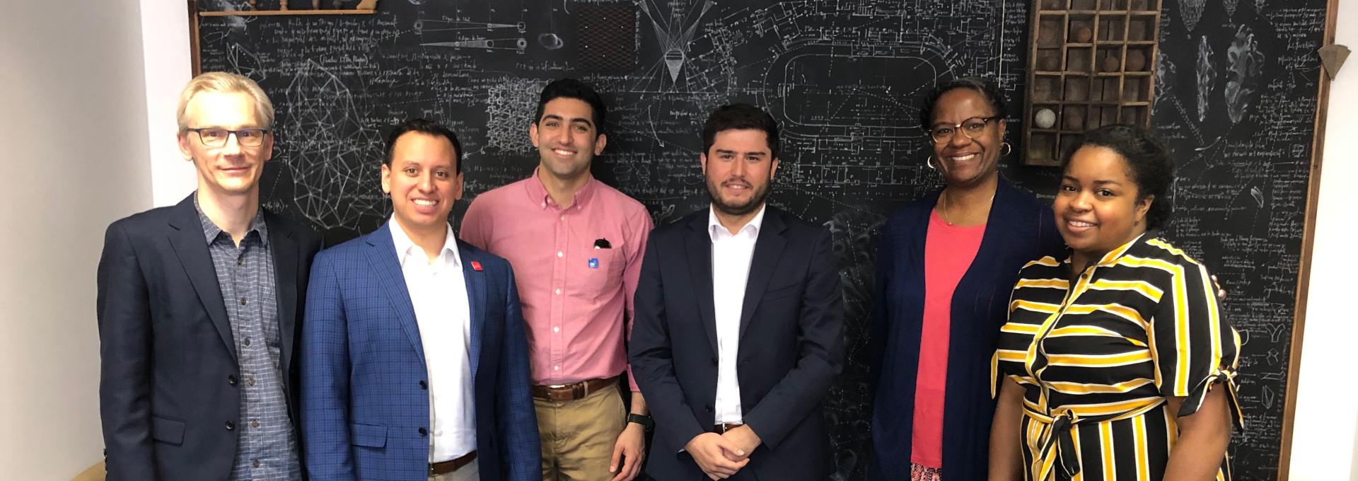 group of people in front of chalkboard