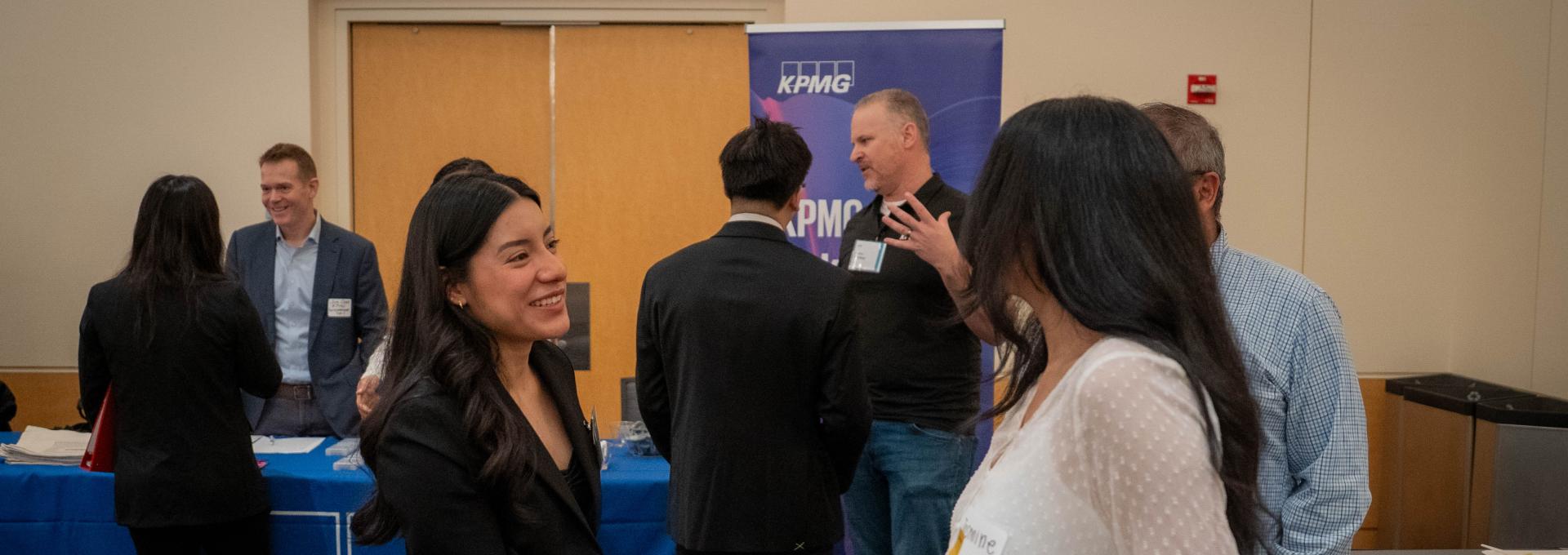 An MPAc student and a recruiter shake hands at the Meet the Firms event