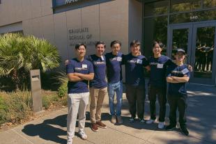 Chris Ngan and other MPAc students stand in front of Gallagher Hall