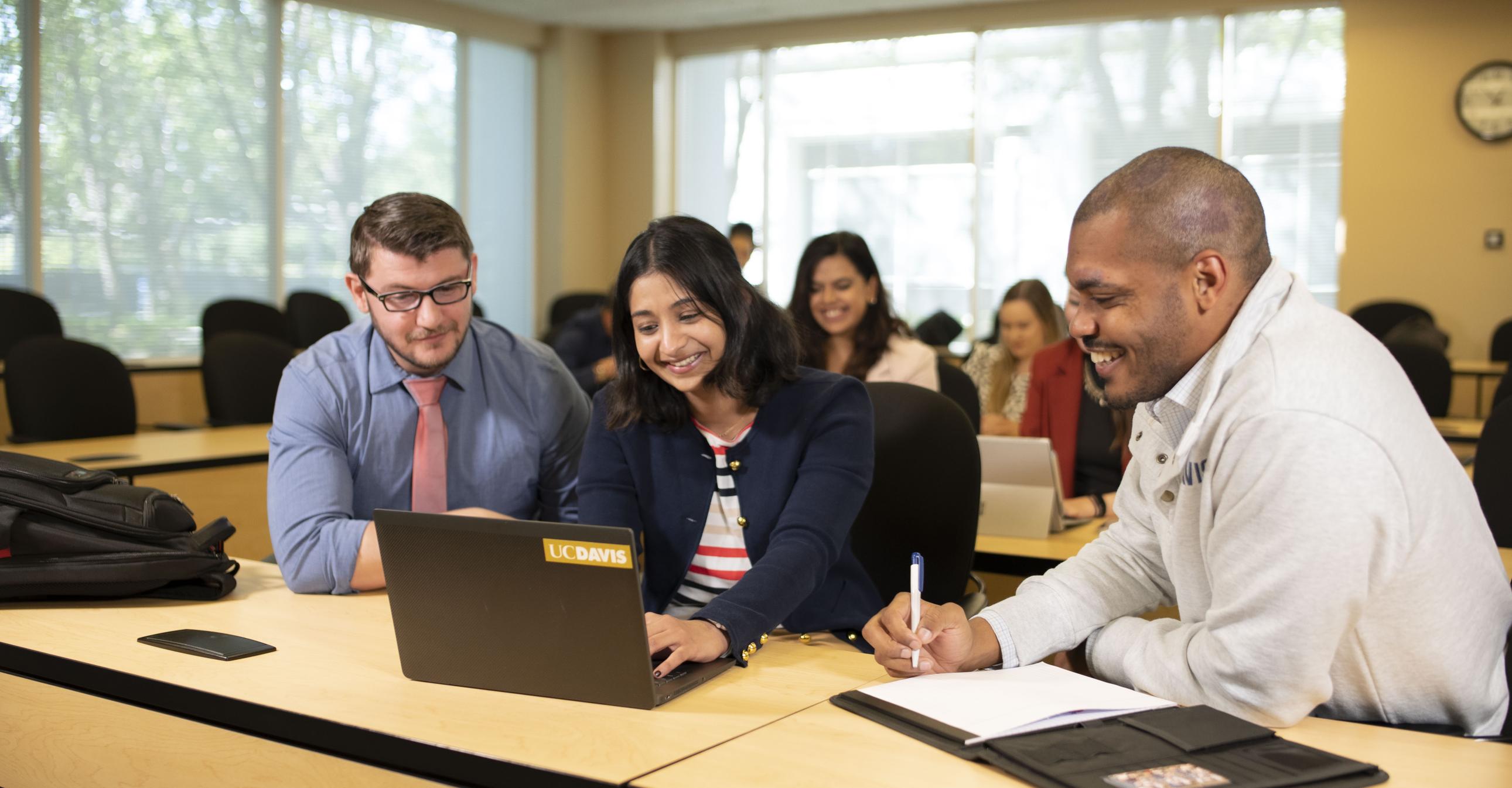 Group of people looking at a laptop