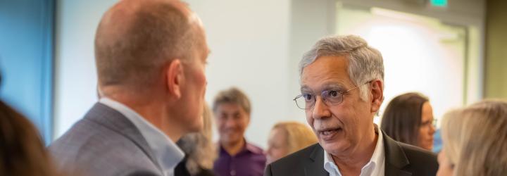 Graduate School of Management Dean Rao Unnava speaks with attendees during a reception at Gallagher Hall before the Dean’s Distinguished Speaker presentation.