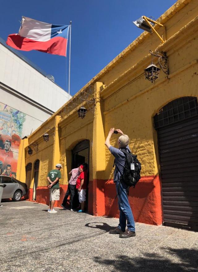 Tourist in Chile photographing Chilean flag
