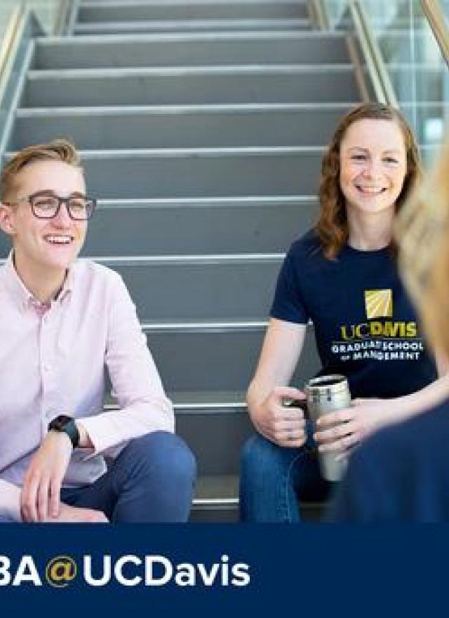 Two students on a stairwell, MBA @ UCDavis text below