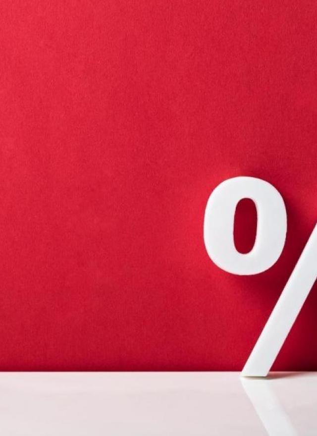 Physical percentage sign on a red background