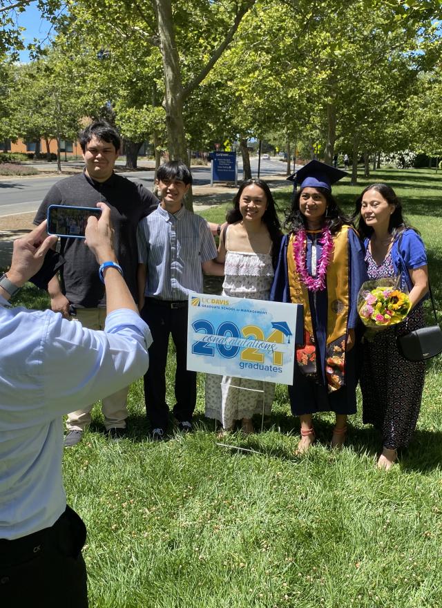 Jessica Padolina and family take a photo at Aggie Grad Walk
