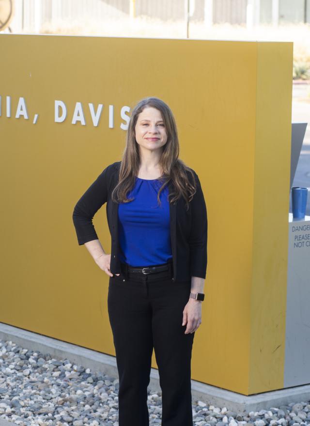 Teri Slack in front of the UC Davis sign