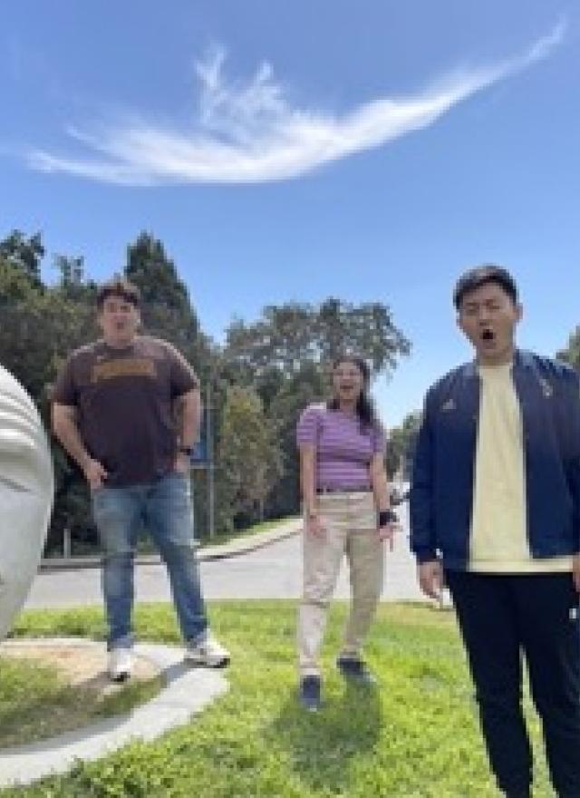 UC Davis students in front of Egghead sculpture
