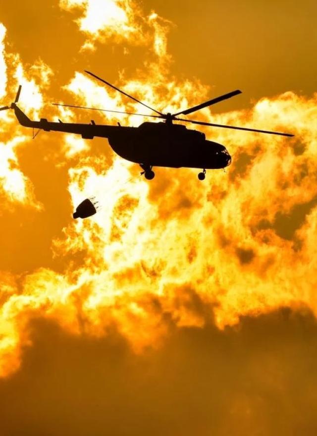 Helicopter over fire sky