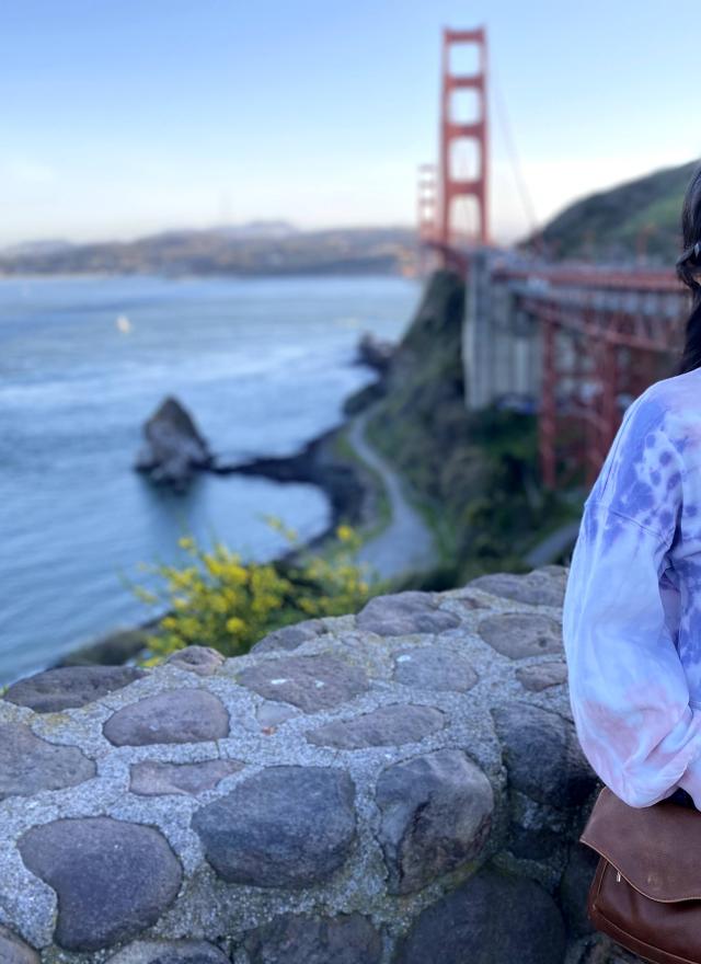 Woman standing in front of the Golden Gate bridge in San Francisco