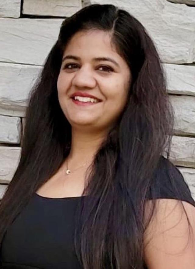 Woman smiling in front of building