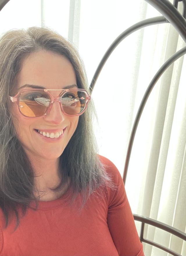 Woman wearing sunglasses and smiling