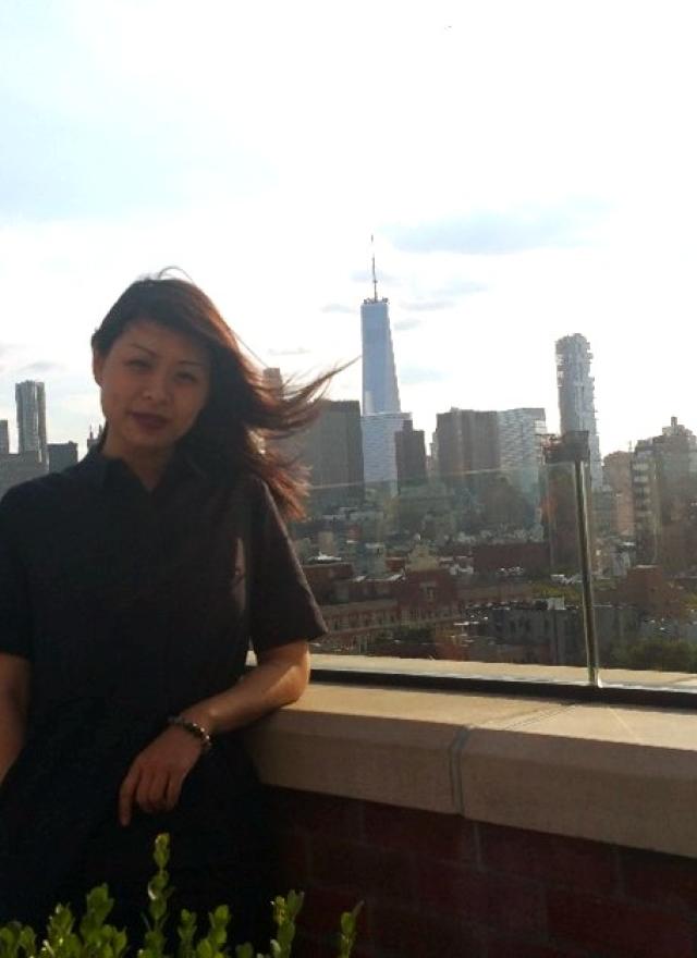 A photo of Faye Wu standing on a rooftop