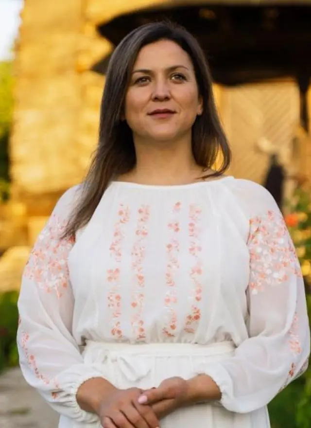 portrait of Aliona Chistol posing outside in a garden