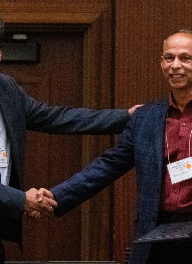 Distinguished Professor Hemant Bhargava (right) accepts the ISS President’s Service Award from Professor Indranil Bardhan