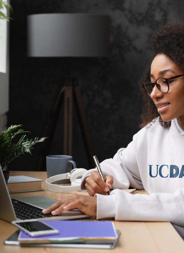 Woman at keyboard wearing UC Davis sweatshirt