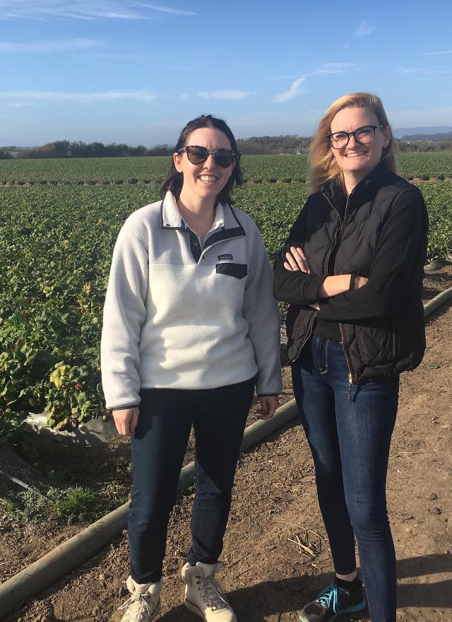 Two women standing in a field during a site visit