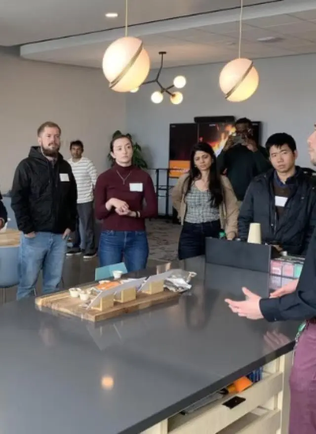 a group of students listening to a speaker demonstration