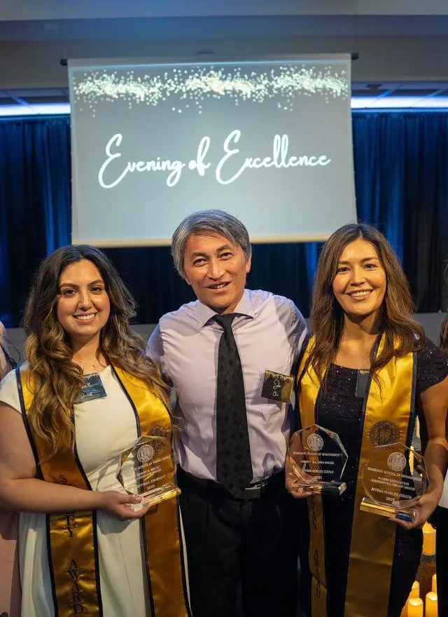 winners holding trophies and certificates