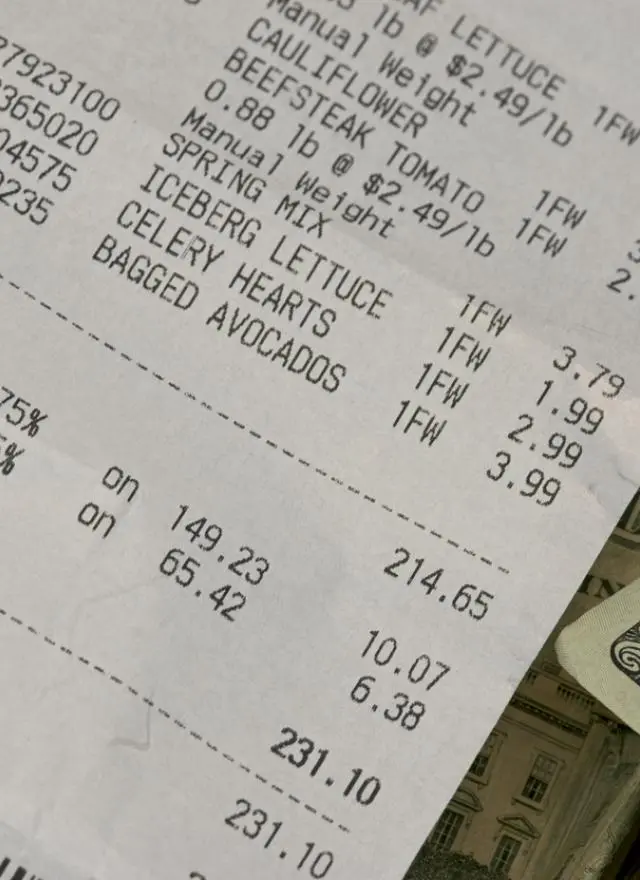 grocery receipt alongside $20 bills 