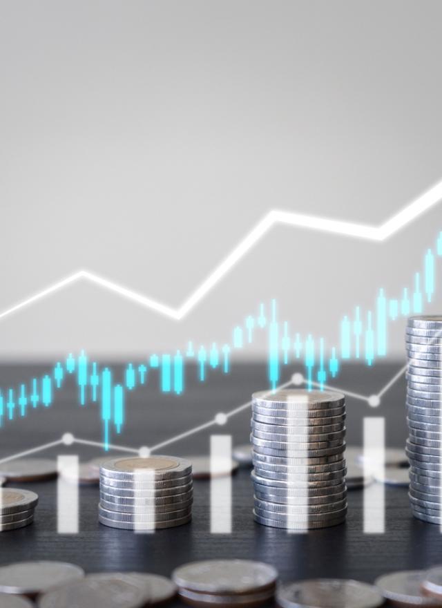 Stacks of coins in ascending order with a white upward-pointing arrow and bar graph overlay, symbolizing financial growth or increasing profits.