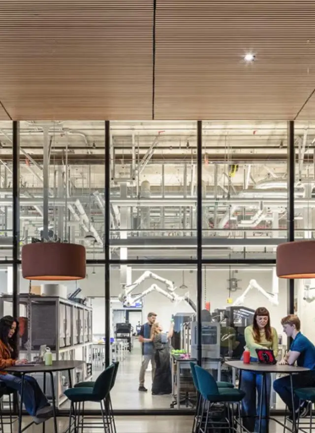 People sit outside of the Tech Foundry, a makerspace at Aggie Square that designs and manufactures devices to support research and solve problems.