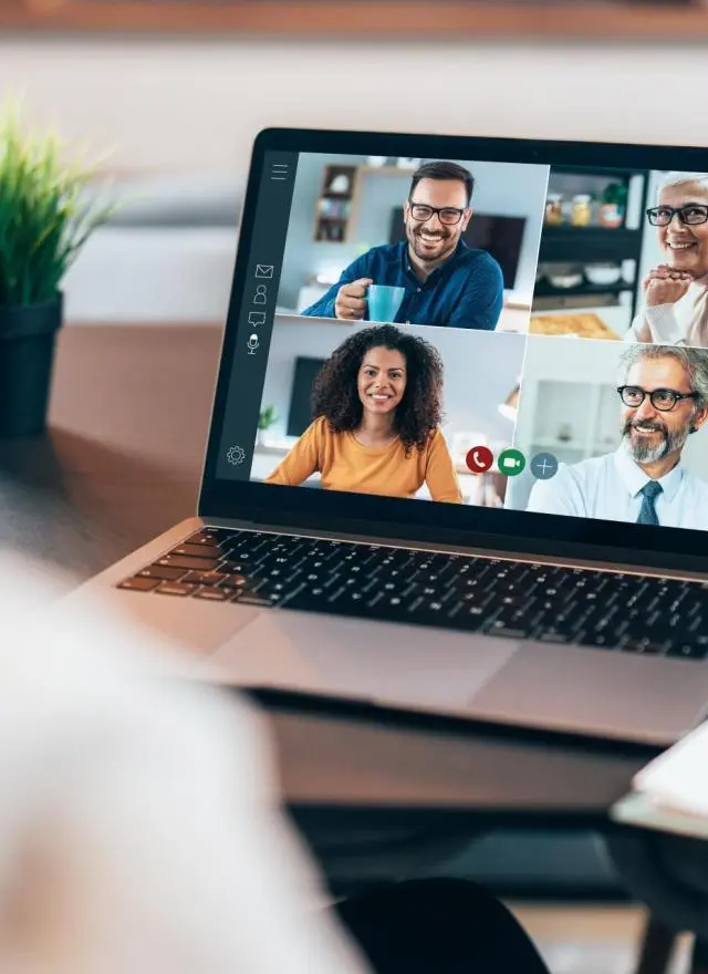 A person on a laptop in a virtual meeting