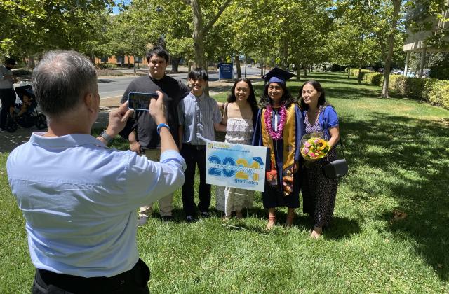 Jessica Padolina and family take a photo at Aggie Grad Walk