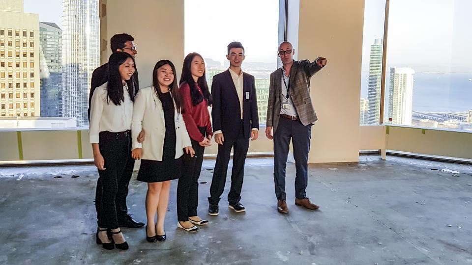 Group of people standing inside a vacant building