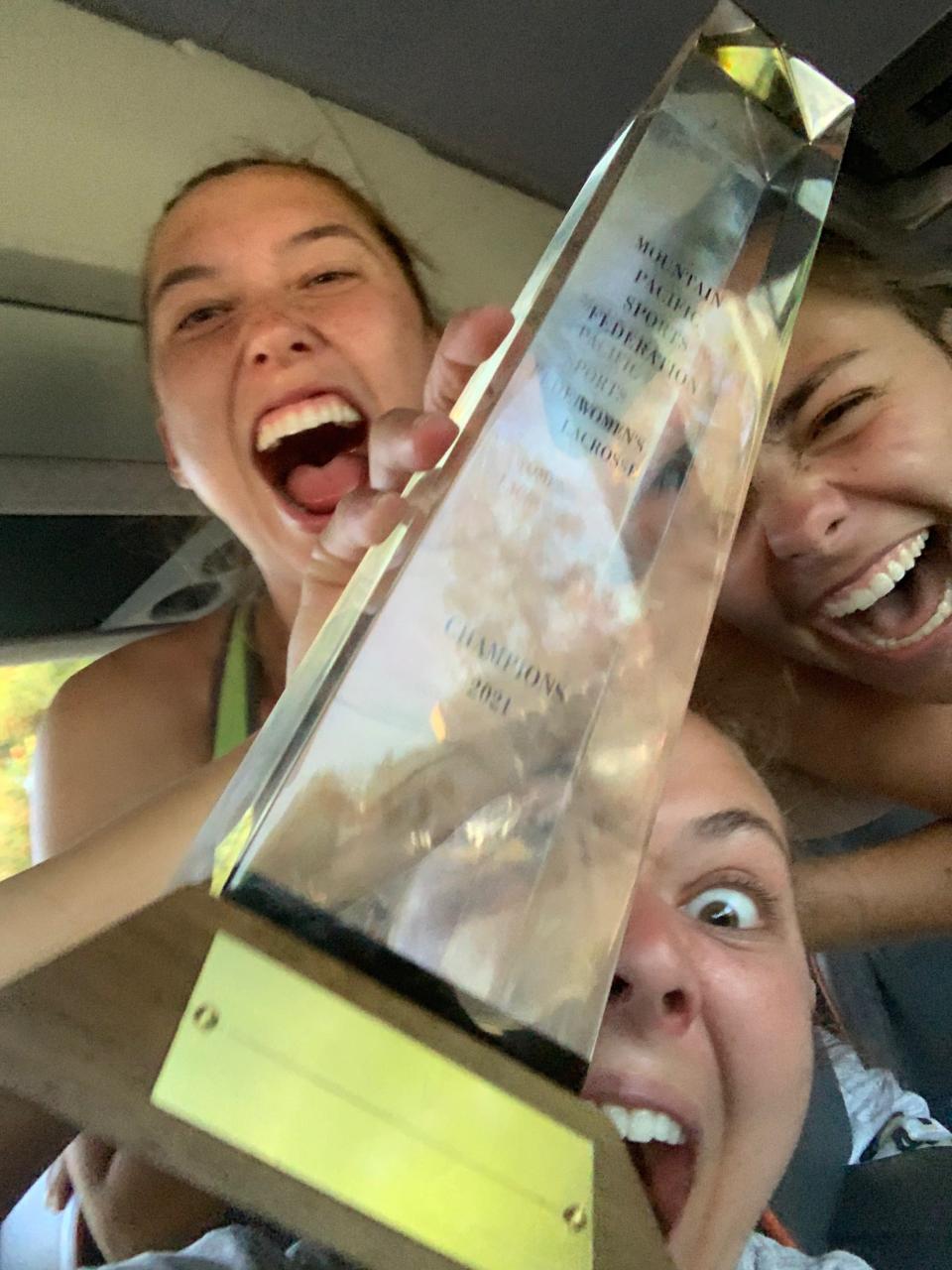 Kate Graham celebrates winning the MPSF tournament championship with her teammates