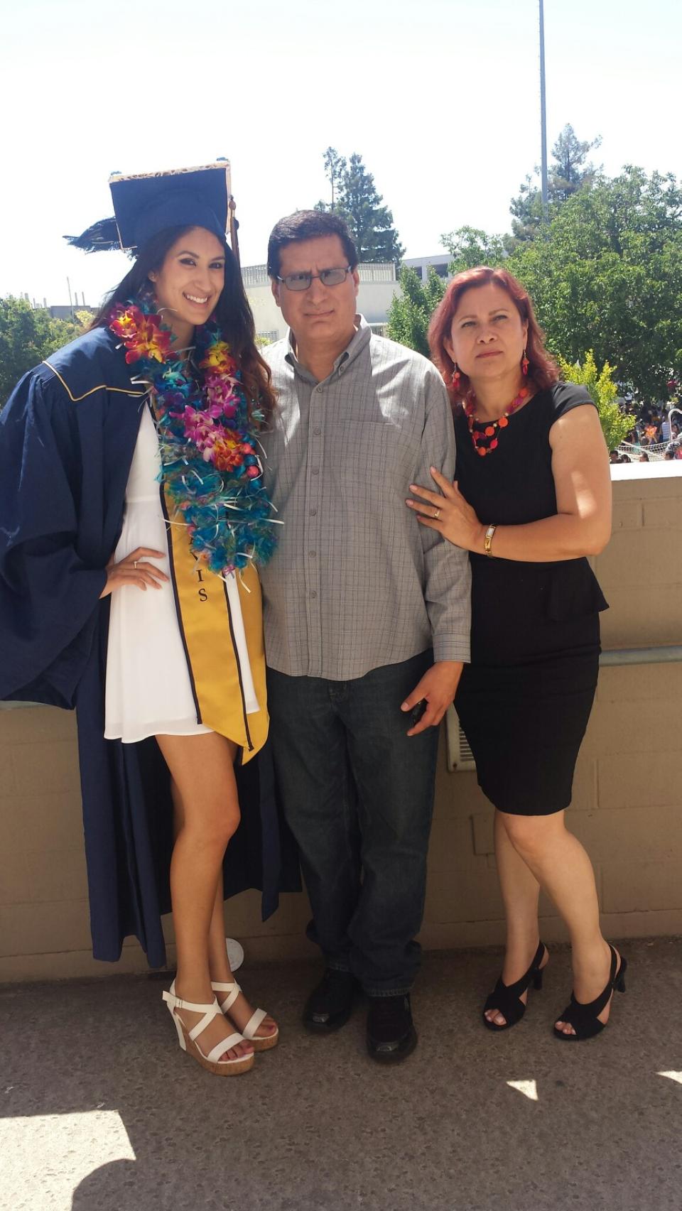 Leticia Garay MBA 24 at her UC Davis undergrad graduation with her parents