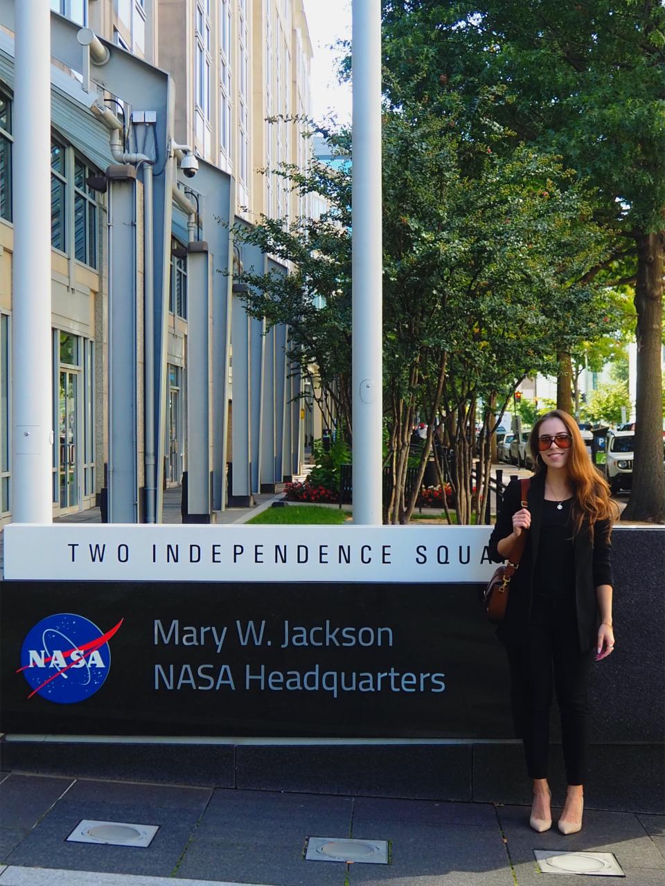 Rushana R. Galeeva standing in front of the Mary W. Jackson NASA headquarters in Washington D.C.