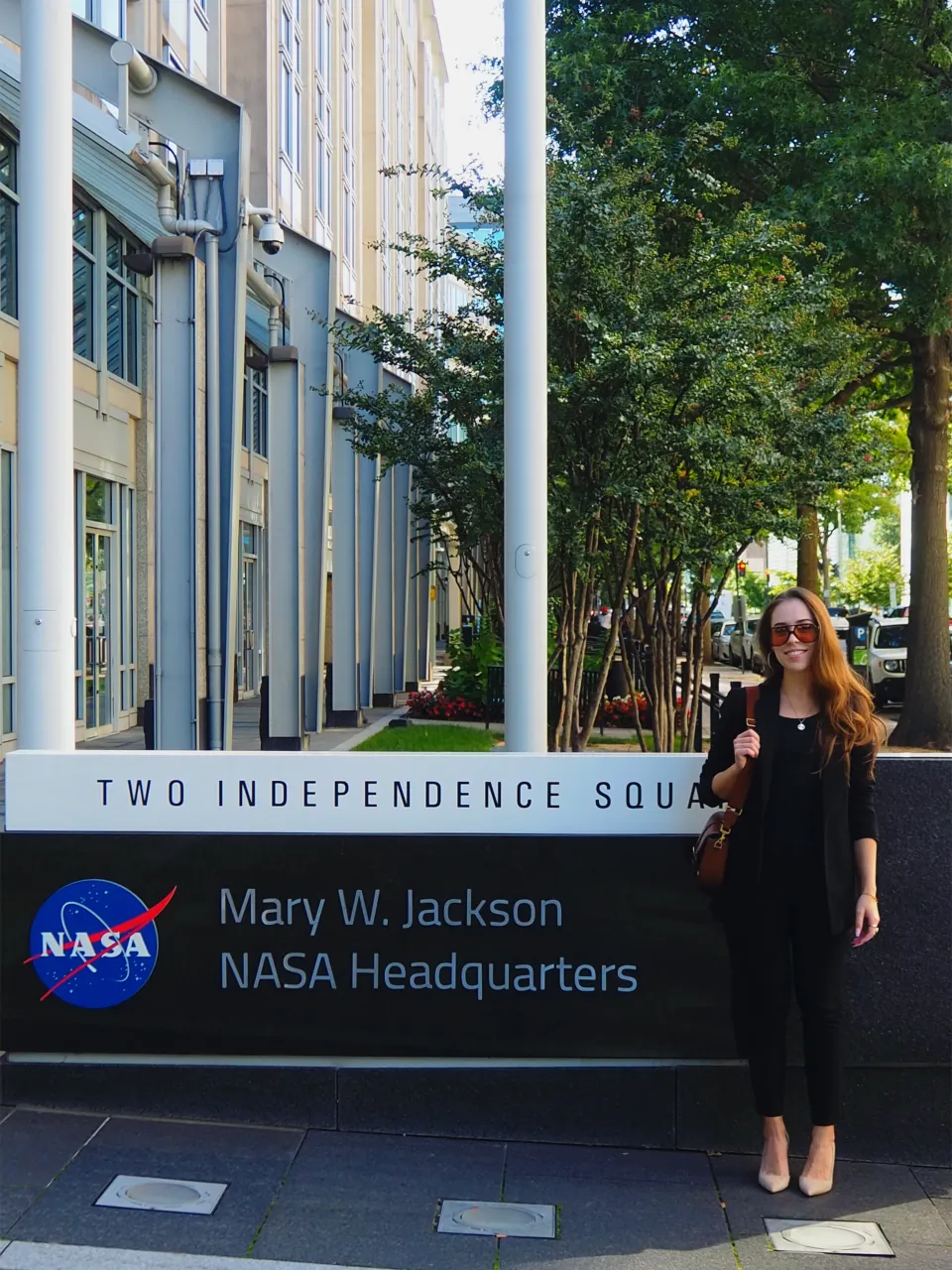 Rushana R. Galeeva standing in front of the Mary W. Jackson NASA headquarters in Washington D.C.