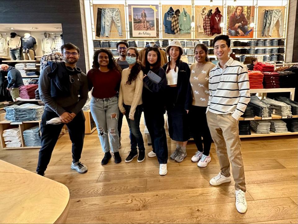 Sayar Banner Banerjee and a group of group of students inside a American Eagle Outfitters retail store