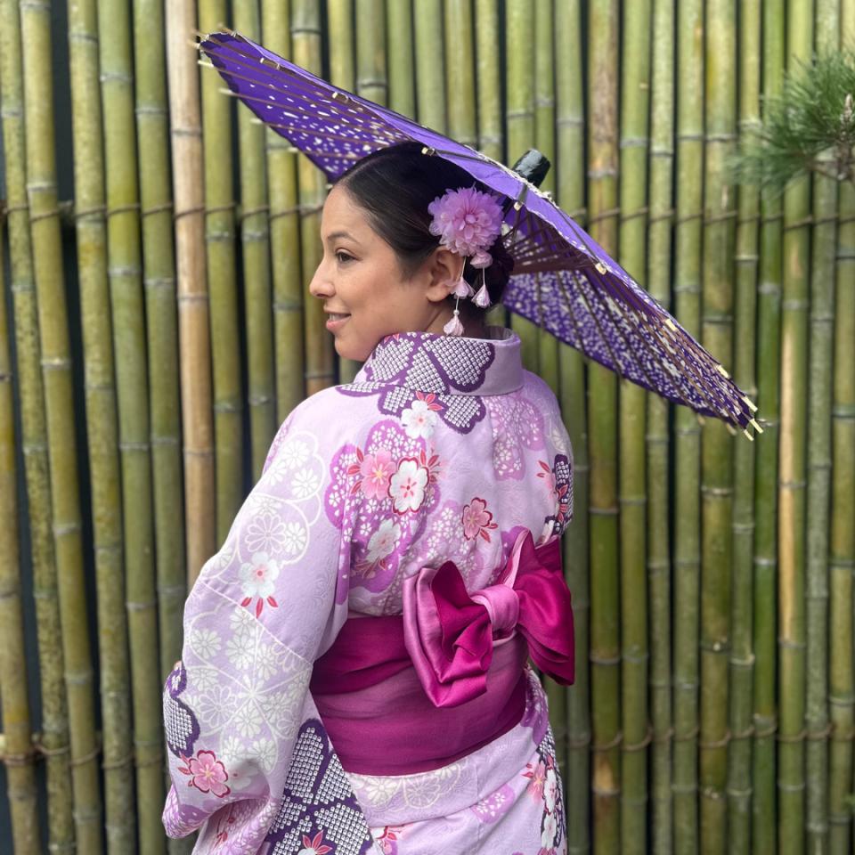 Alice Vega wearing a  purple and pink kimono and holding a parasol
