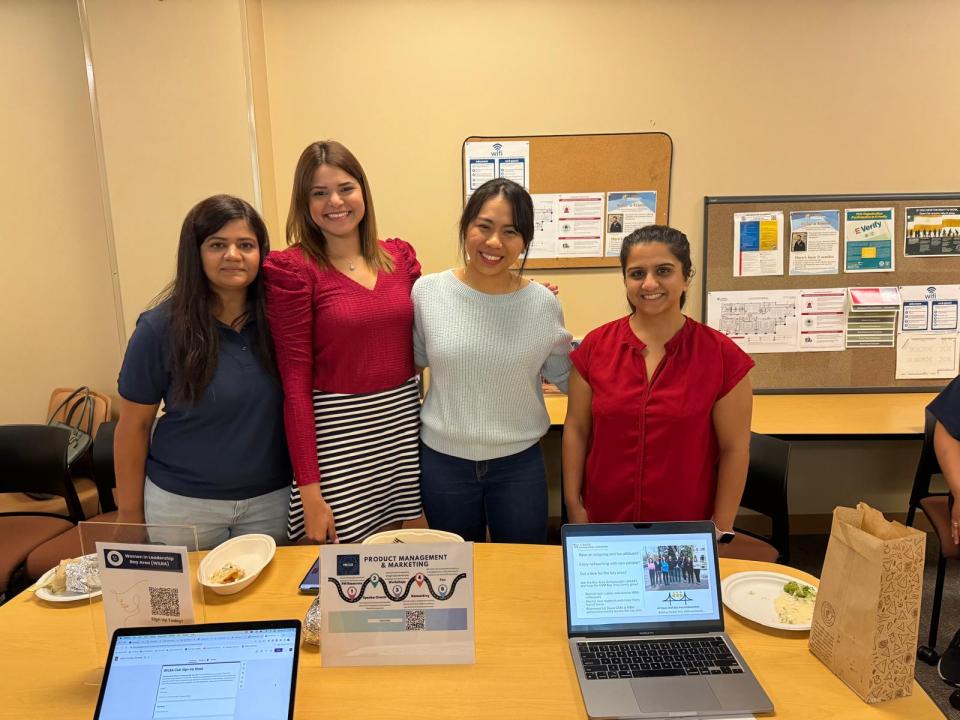 Anuja Gupta with three MBA students in a classroom