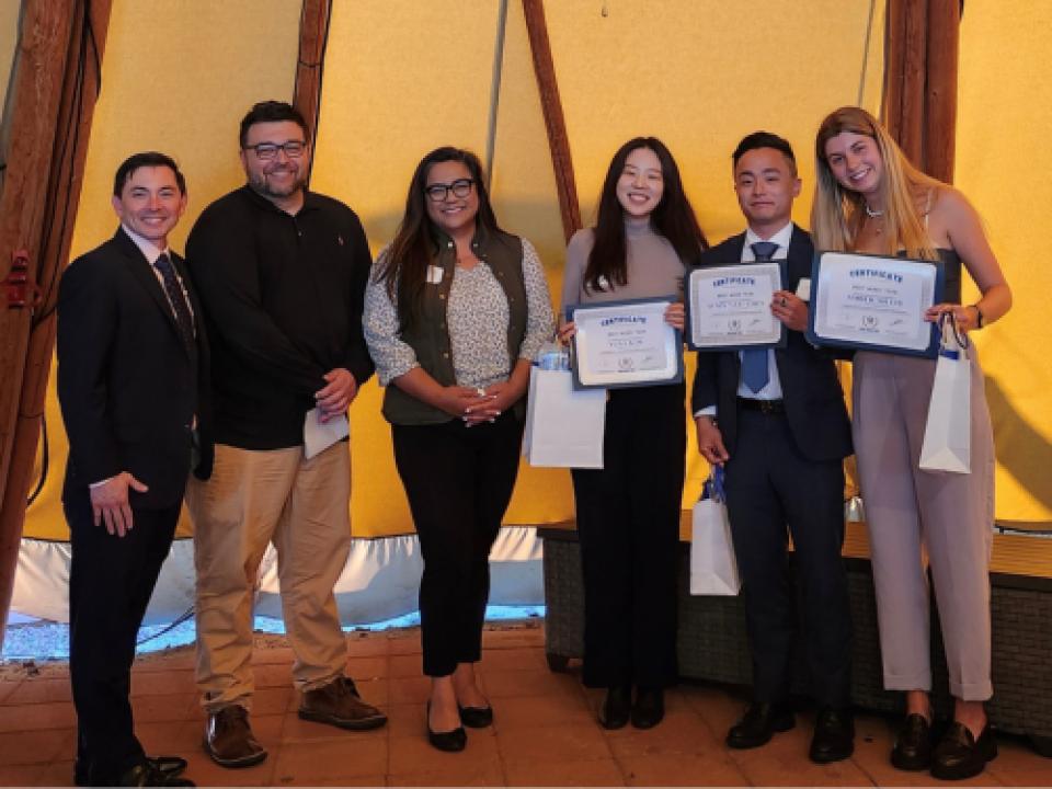 group of people holding up certificates