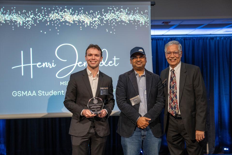 Henri Jenoudet on-stage receiving award from Dean Rao Unnava
