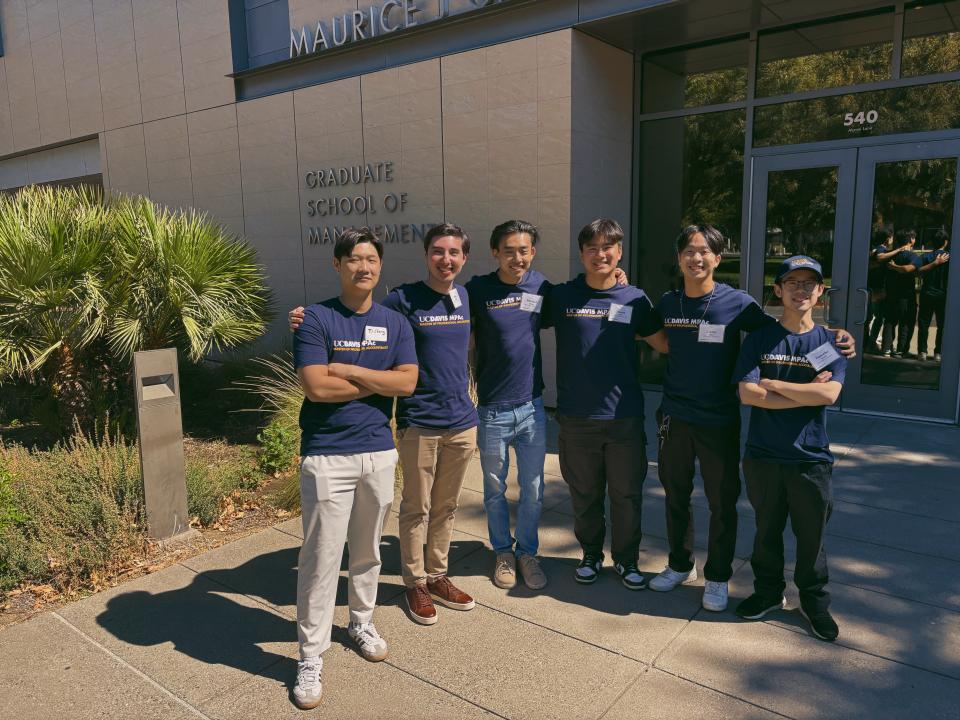 Chris Ngan and other MPAc students stand in front of Gallagher Hall