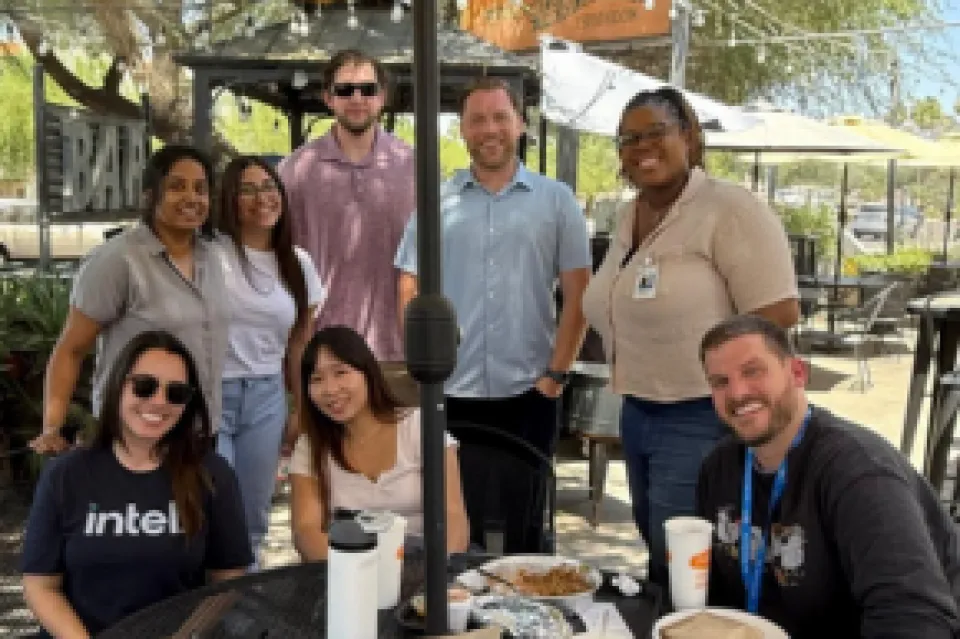 Nathaniel Wentland sitting on a patio with other Intel interns