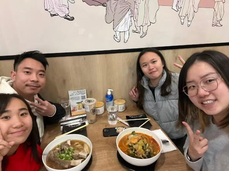 Selina Bina eating lunch in a restaurant with other MSBA students