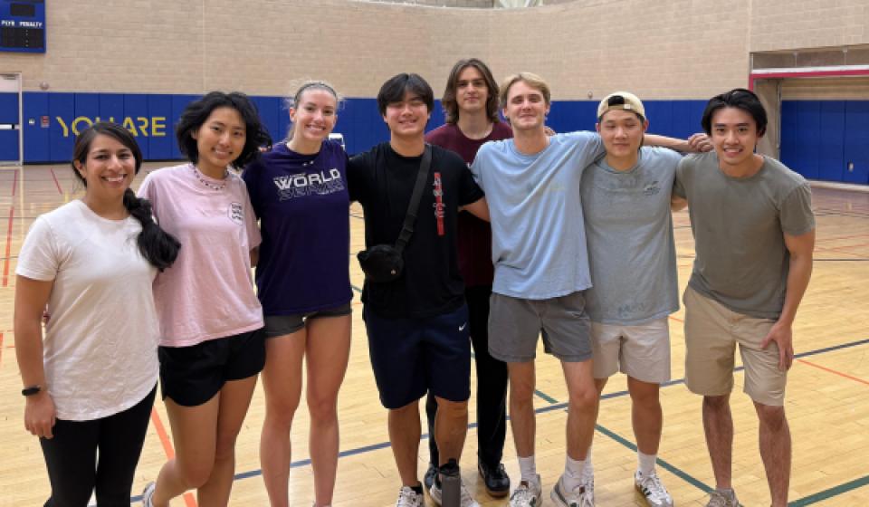 UC Davis students pose for a group photo inside the ARC gym after a volleyball game.