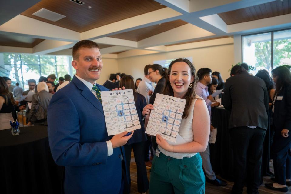 Natalie Webster and Nathaniel Wentland  smiling and holding up bingo cameras