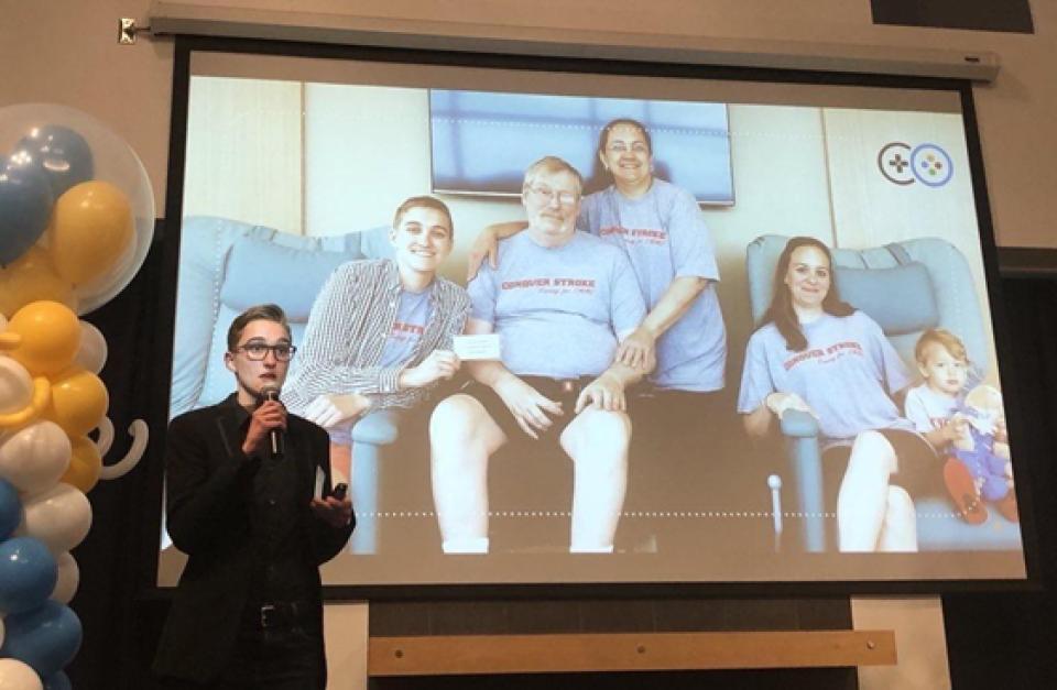 Sara Howard standing in front of a slide, featuring a photo of her family