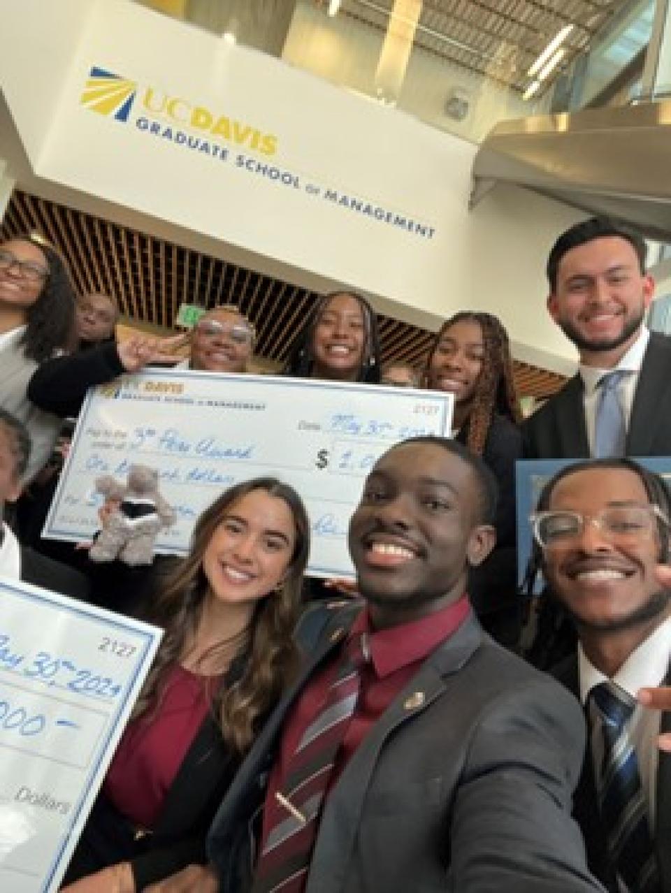 A group of people holding a check